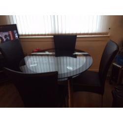 Glass Dinning Table with Stainless Steel legs with 4 High Back Leather Seats