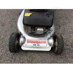 Petrol mower with rear roller