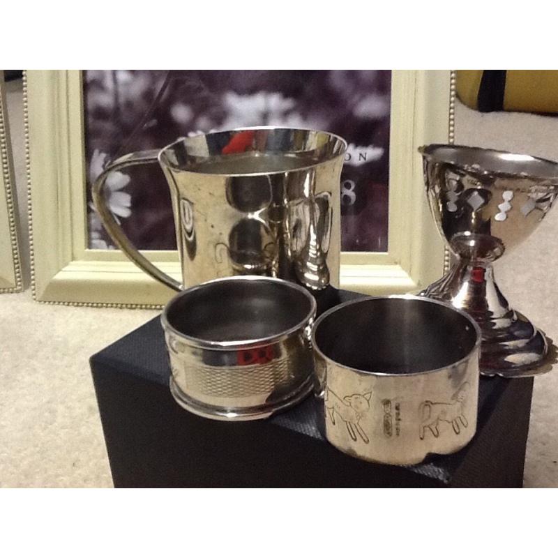 Childs four piece silver napkin cup and egg cup