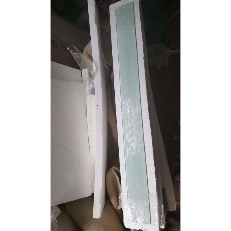 Unused toughened glass splashback and window-sill covering in subtle pistachio tint