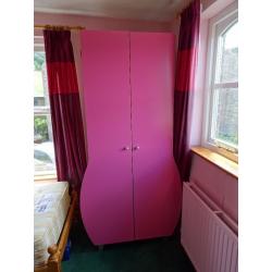 Children's matching pink wardrobe and chest of drawer. Can be bought separately.