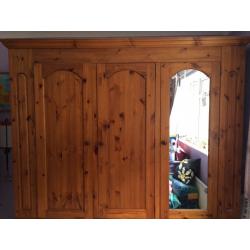 Solid pine 3door Wardrobe with mirror on one. It is 208cm high, 200 cm wide and 56 cm deep