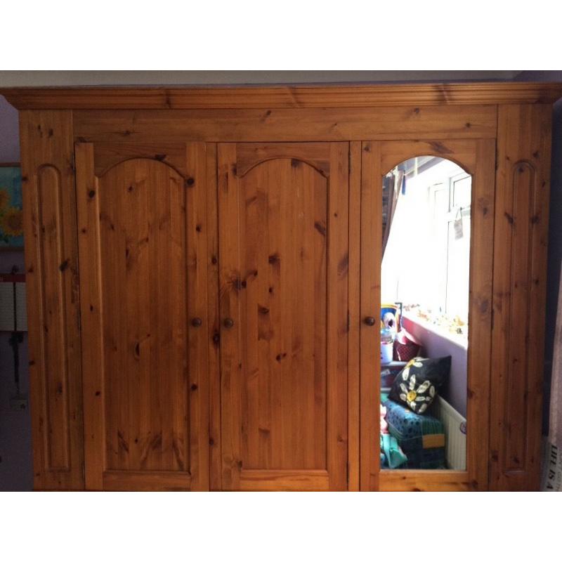 Solid pine 3door Wardrobe with mirror on one. It is 208cm high, 200 cm wide and 56 cm deep