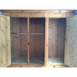 Solid pine 3door Wardrobe with mirror on one. It is 208cm high, 200 cm wide and 56 cm deep
