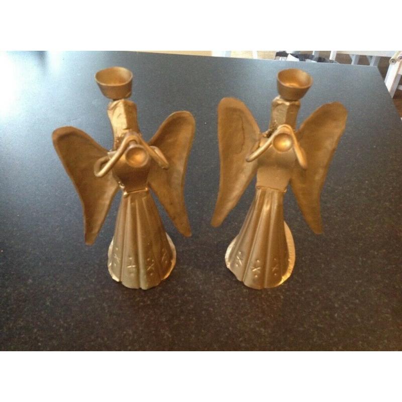 Pair of metal angel candle holders.