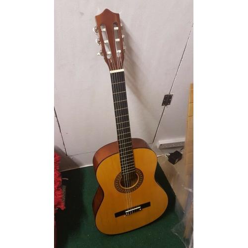 Acoustic Guitar - wooden - hardly used - great condition.