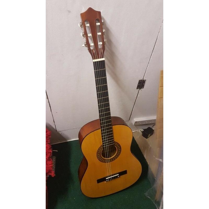 Acoustic Guitar - wooden - hardly used - great condition.